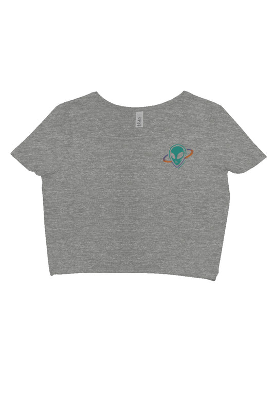 Light grey crop top with small alien head in orbit ring on upper left chest.